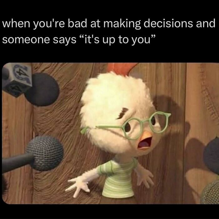 Cartoon character wearing glasses looking confused in front of microphones, representing introvert-worthy memes about decision making.