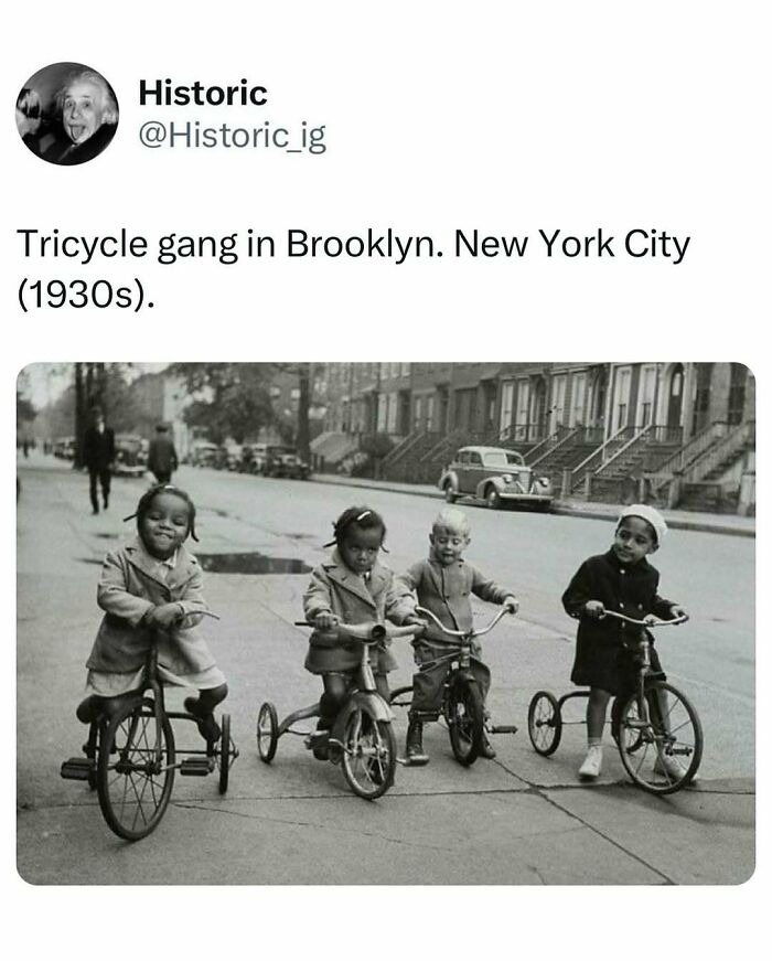 Four children on tricycles in Brooklyn, New York City street scene from the 1930s in an interesting historic photo.