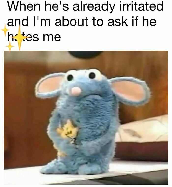 Blue plush mouse holding a small yellow figure looking nervous, a funny meme for daily dose of laughter and good vibes.