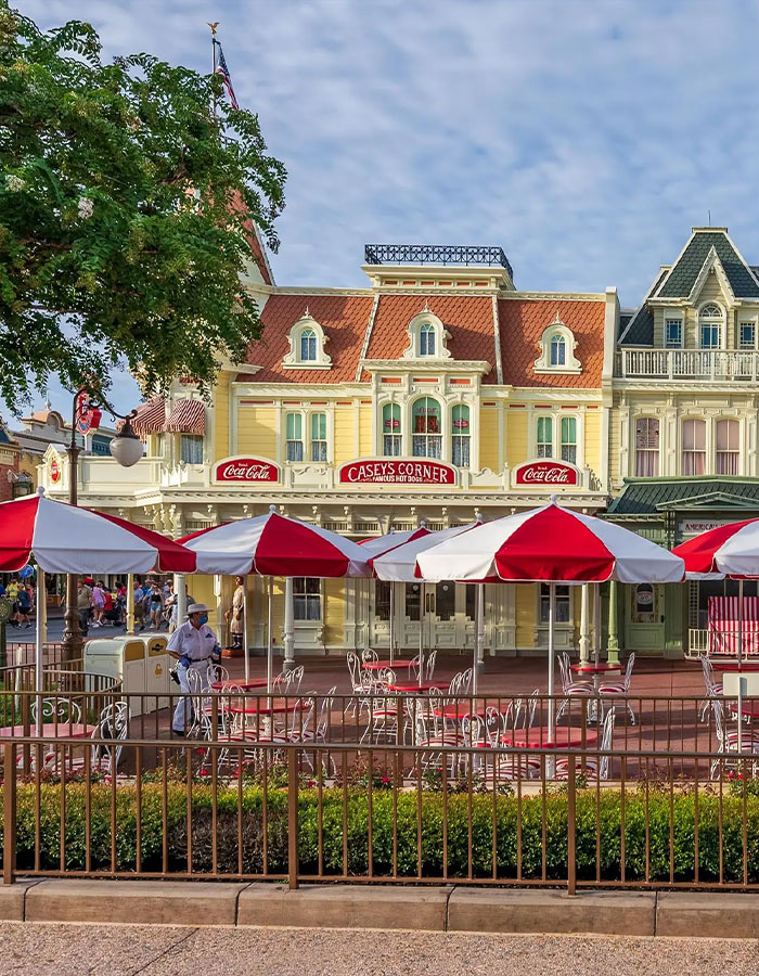 Outdoor seating with red and white umbrellas at Casey's Corner in Disney World, linked to violent Disney World incident keywords. Outdoor seating with red and white umbrellas at Casey's Corner in Disney World, linked to violent Disney World incident keywords.