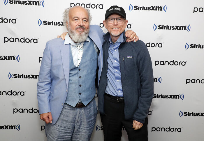 Two men posing together at a SiriusXM event, representing legendary entertainment families passing the spotlight down generations.