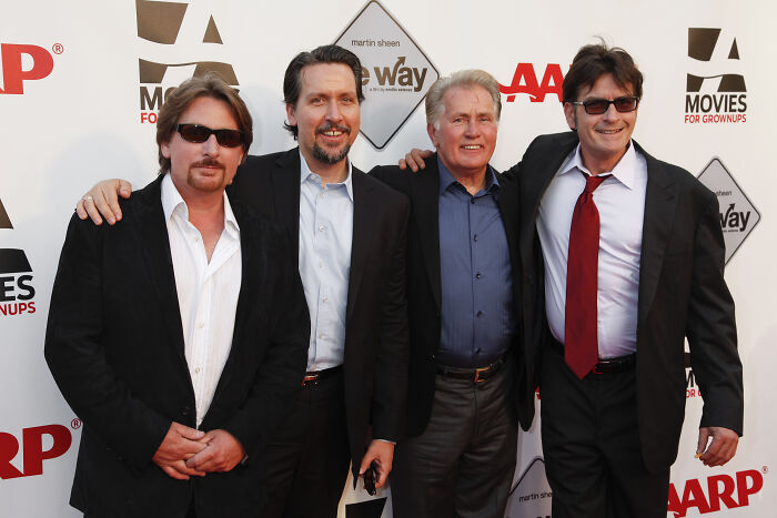 Four men posing together on the red carpet at an event, representing legendary entertainment families spanning generations.
