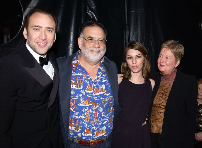Nicolas Cage and family members posing together at an event, representing legendary entertainment families.