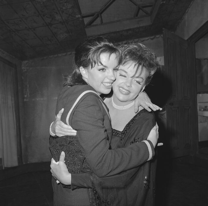 Two women warmly embracing each other, representing legendary entertainment families passing the spotlight through generations.