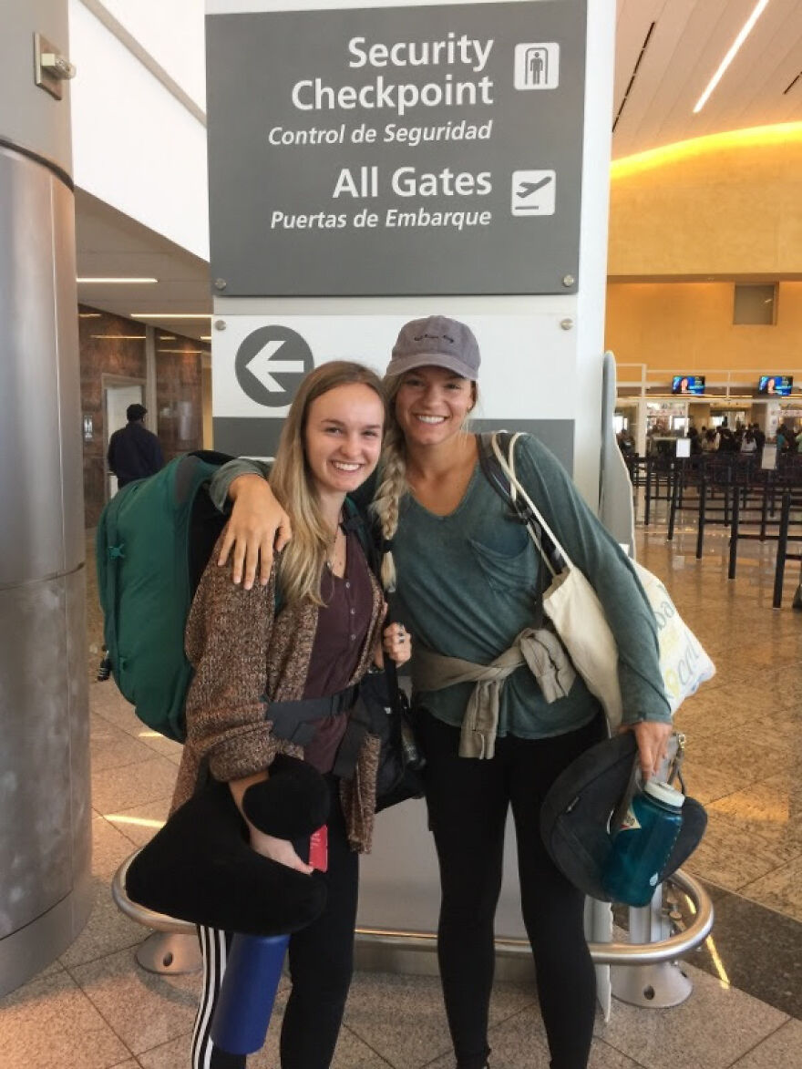 Two young women at airport security checkpoint smiling, ready for a one-way flight to Australia with backpacks and travel gear. Two young women at airport security checkpoint smiling, ready for a one-way flight to Australia with backpacks and travel gear.