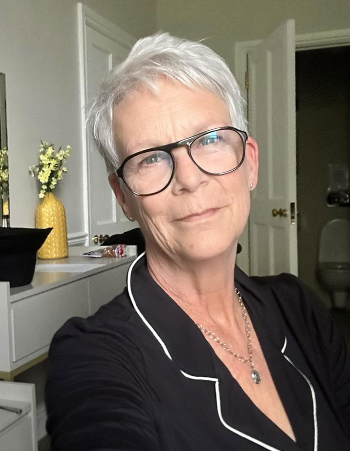 Jamie Lee Curtis wearing glasses and black top, responding to fan memes about her viral cleavage moment. Jamie Lee Curtis wearing glasses and black top, responding to fan memes about her viral cleavage moment.
