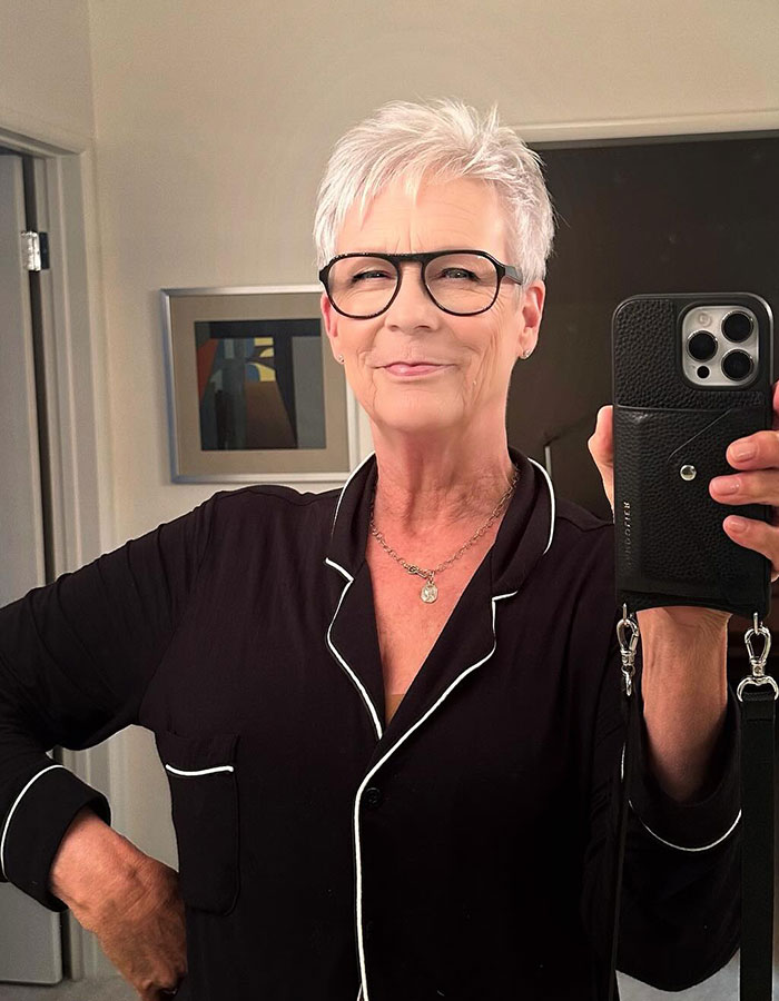 Jamie Lee Curtis taking a selfie wearing glasses and black pajamas, responding to viral fan memes about her cleavage moment. Jamie Lee Curtis taking a selfie wearing glasses and black pajamas, responding to viral fan memes about her cleavage moment.