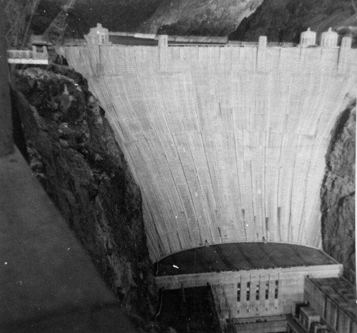 Historic black and white photo of Hoover Dam construction, showcasing the birth of Vegas infrastructure development.