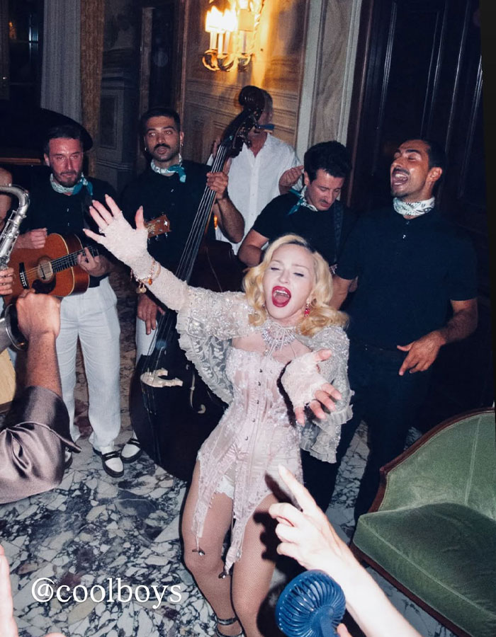 Madonna happily performing with a live band, embracing change as she follows her boyfriend's cosmetic advice. Madonna happily performing with a live band, embracing change as she follows her boyfriend's cosmetic advice.