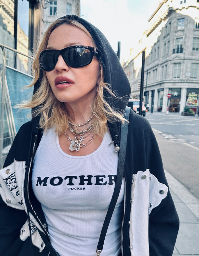 Madonna wearing sunglasses and a hoodie on city street, highlighting cosmetic change advice from her 29YO boyfriend. Madonna wearing sunglasses and a hoodie on city street, highlighting cosmetic change advice from her 29YO boyfriend.