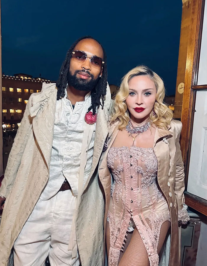 Madonna with her 29-year-old boyfriend at night, both dressed in stylish vintage-inspired outfits outdoors. Madonna with her 29-year-old boyfriend at night, both dressed in stylish vintage-inspired outfits outdoors.