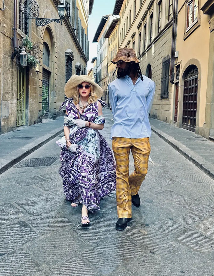 Madonna walking with her boyfriend in vintage style outfits on a cobblestone street, embracing cosmetic change advice. Madonna walking with her boyfriend in vintage style outfits on a cobblestone street, embracing cosmetic change advice.