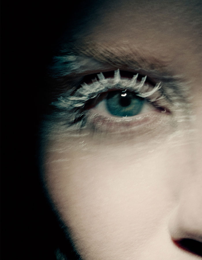 Close-up of an eye with white body paint lashes in Miley Cyrus' body paint campaign for Maison Margiela. Close-up of an eye with white body paint lashes in Miley Cyrus' body paint campaign for Maison Margiela.