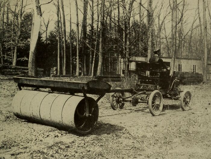 Early 20th century car with large roller attachment, showcasing how wild the first cars really were 100 years ago.