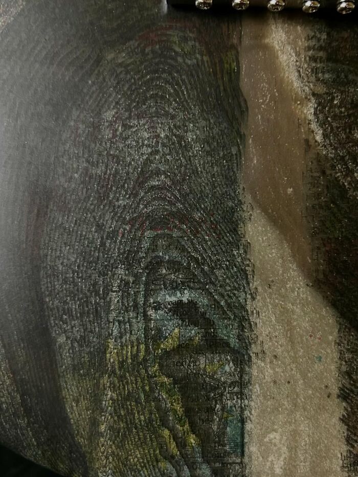 Close-up of a guitar body made from stacked newspapers shaped using a 3D mold, showcasing layered texture and print.