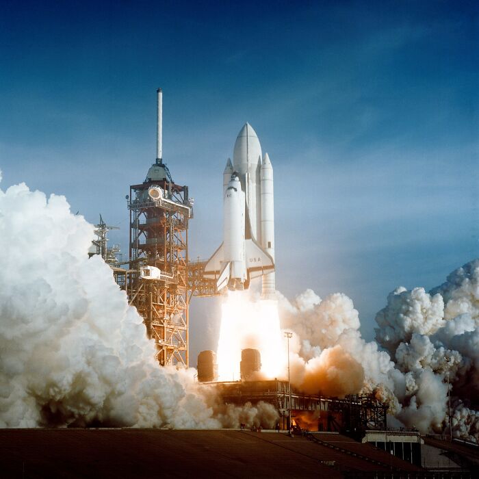 Space shuttle launching with flames and smoke showcasing record-breaking inventions moving at mind-blowing speeds.