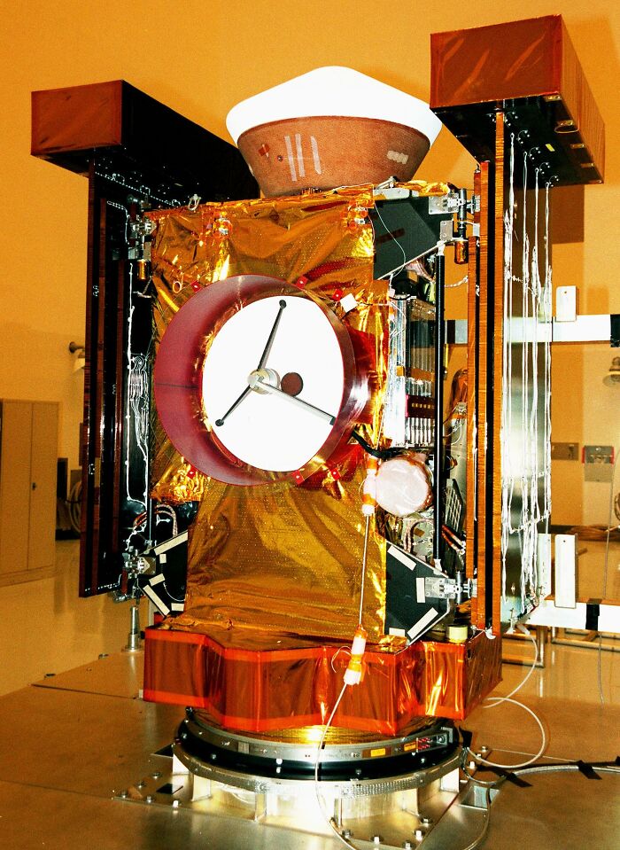 High-tech spacecraft invention with reflective gold foil and scientific instruments representing record-breaking inventions at mind-blowing speeds.