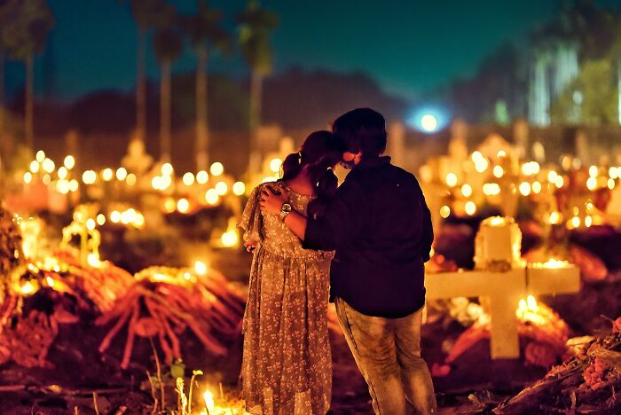 Couple embracing among glowing candles at night, capturing vivid photos of India bursting with color and life.