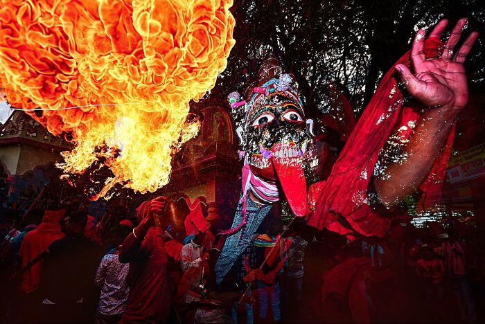 Colorful fire-breathing performer in vibrant cultural festival, showcasing vivid photos of India bursting with color and life.