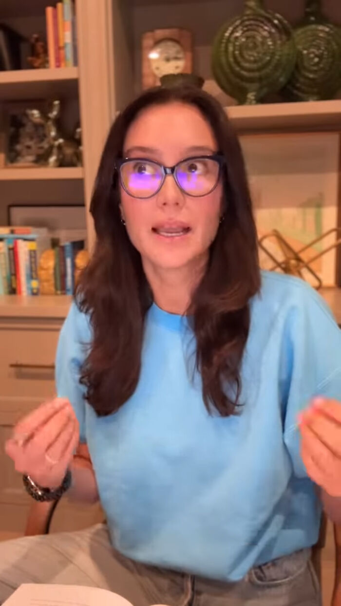 Bruce Willis's wife wearing glasses and blue shirt sharing an update on their separate living during his dementia battle. Bruce Willis's wife wearing glasses and blue shirt sharing an update on their separate living during his dementia battle.