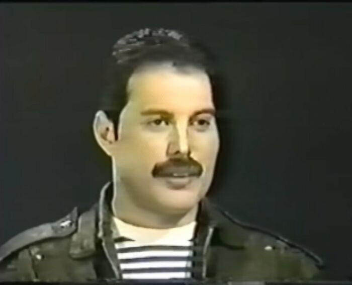 Man with mustache and striped shirt speaking in a vintage video, illustrating videos that gain meaning with more context
