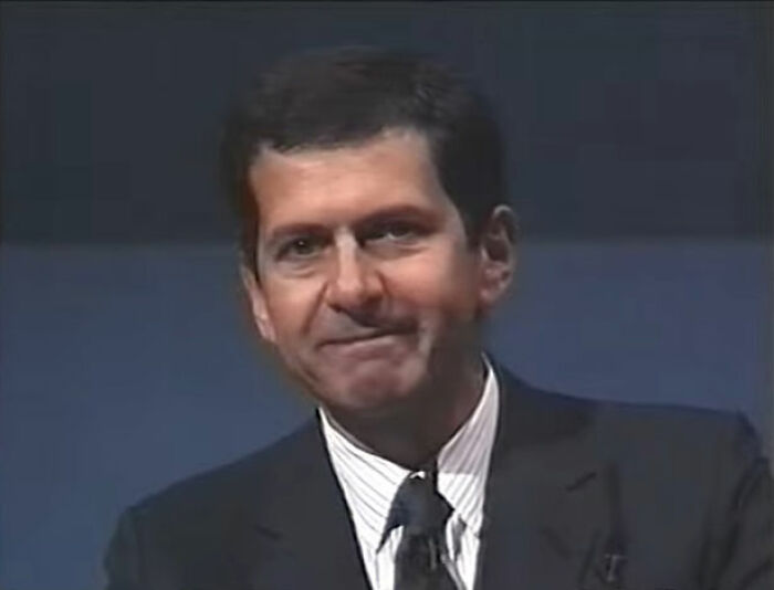 Man in a dark suit and tie sitting against a dark background, illustrating PR campaigns and decisions fails concept.