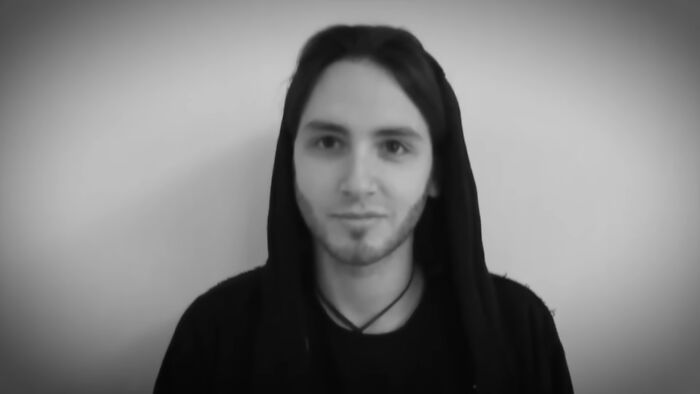Young man in a black hoodie against a plain background, featured in videos that gain meaning with context.