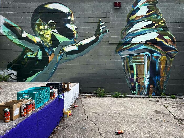 Colorful mural blending graffiti and realism shows a child reaching for an abstract ice cream cone on wall.