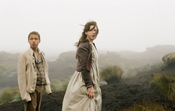 Two actors in period clothing on a foggy moorland setting, from the controversial Wuthering Heights adaptation. Two actors in period clothing on a foggy moorland setting, from the controversial Wuthering Heights adaptation.