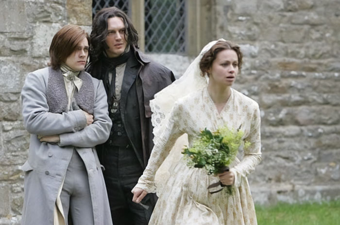 Three actors in period costumes from a Wuthering Heights adaptation portraying tense and dramatic scenes outdoors. Three actors in period costumes from a Wuthering Heights adaptation portraying tense and dramatic scenes outdoors.