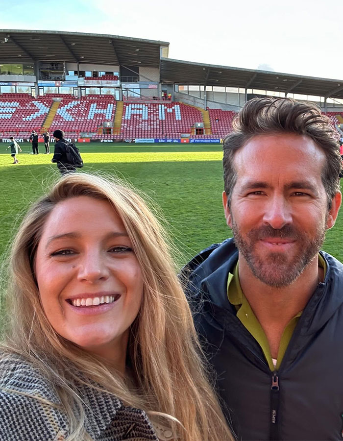 Blake Lively and Ryan Reynolds smiling in a stadium, highlighting Blake Lively leading role in new rom-com. Blake Lively and Ryan Reynolds smiling in a stadium, highlighting Blake Lively leading role in new rom-com.