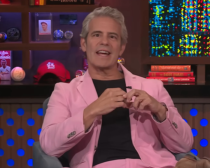 Andy Cohen in a pink suit during a viral moment roasting anti-LGBTQ activist Kim Davis on a TV talk show set. Andy Cohen in a pink suit during a viral moment roasting anti-LGBTQ activist Kim Davis on a TV talk show set.