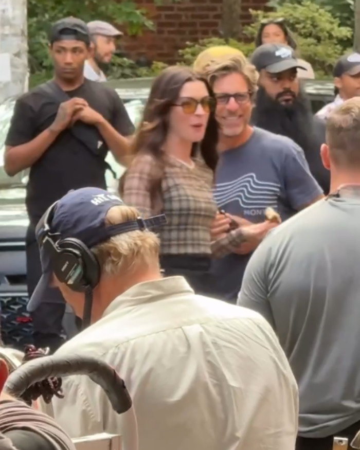 Anne Hathaway surrounded by crew on set, wearing sunglasses, during filming related to heel breaking incident in viral video. Anne Hathaway surrounded by crew on set, wearing sunglasses, during filming related to heel breaking incident in viral video.