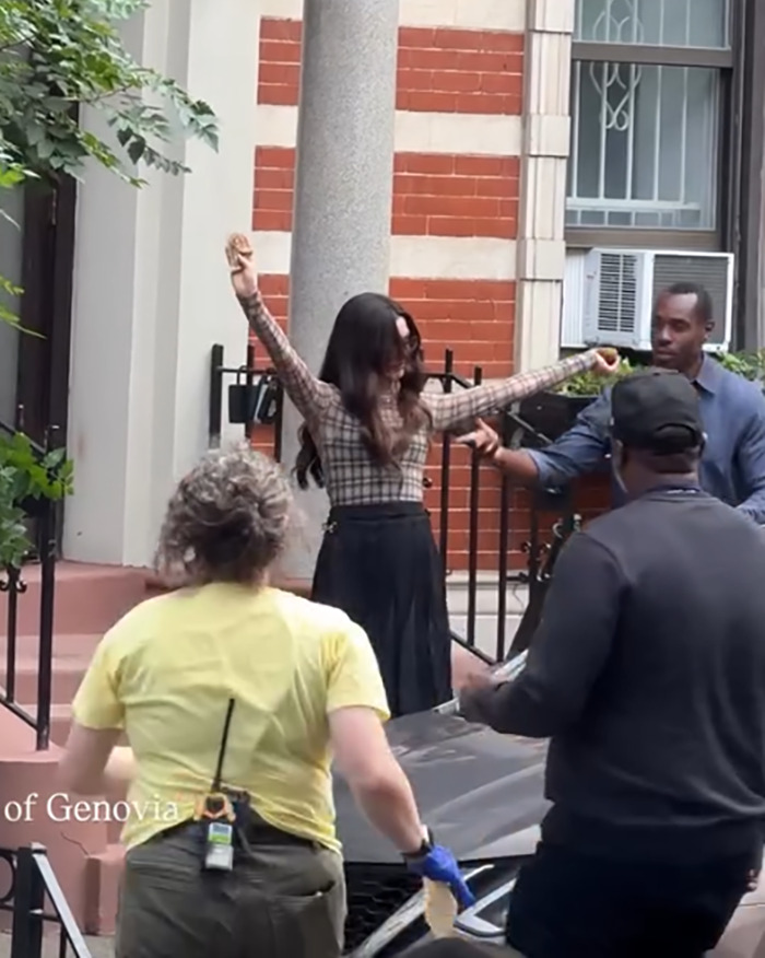 Anne Hathaway falling off stairs while her heel breaks on the set of The Devil Wears Prada 2 with crew around her. Anne Hathaway falling off stairs while her heel breaks on the set of The Devil Wears Prada 2 with crew around her.
