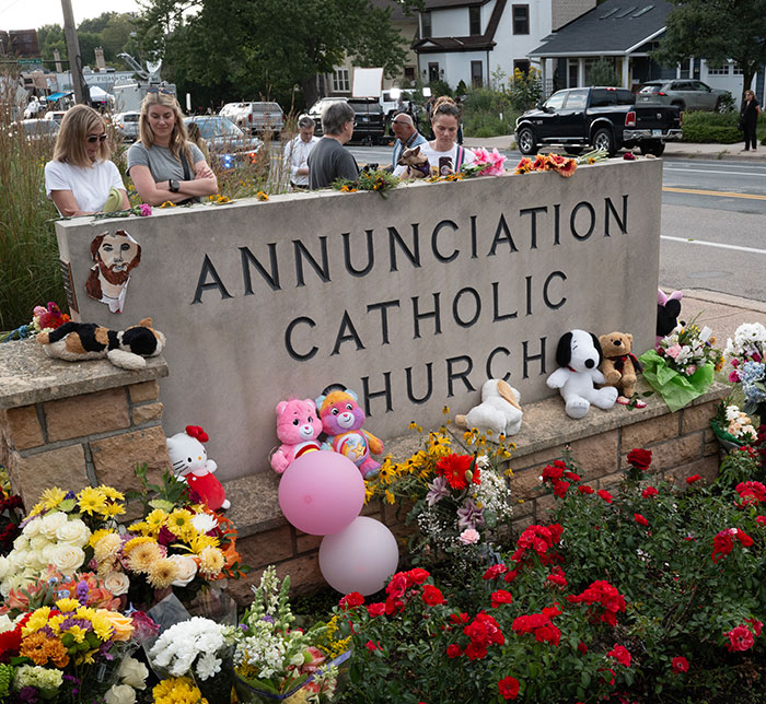 Community gathers at Annunciation Catholic Church memorial after Minneapolis school attacker, mother not cooperating with police. Community gathers at Annunciation Catholic Church memorial after Minneapolis school attacker, mother not cooperating with police.