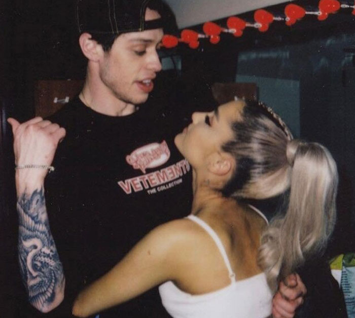 Pete Davidson and a woman closely interacting indoors, highlighting scrutiny on the size of his manhood in the media. Pete Davidson and a woman closely interacting indoors, highlighting scrutiny on the size of his manhood in the media.