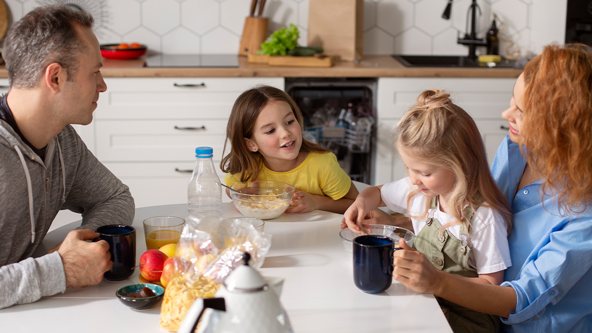 Family enjoying breakfast together in a kitchen, illustrating words that donu2019t exist in English but used in other languages.
