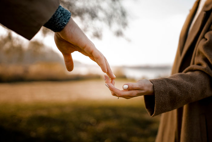 Hands of a widow and her late husband's first wife reaching out, symbolizing family ties and stepkids feeling hurt. Hands of a widow and her late husband's first wife reaching out, symbolizing family ties and stepkids feeling hurt.