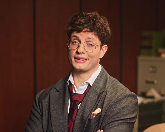 Comedian Matt Rife wearing glasses and a gray suit, posing confidently in an indoor setting. Comedian Matt Rife wearing glasses and a gray suit, posing confidently in an indoor setting.