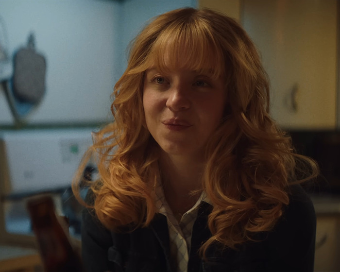 Sydney Sweeney in a dimly lit room, with curly hair, relating to the viral ad backlash and Matt Rife support. Sydney Sweeney in a dimly lit room, with curly hair, relating to the viral ad backlash and Matt Rife support.