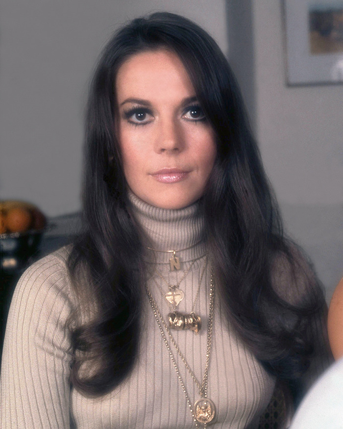 Woman with long dark hair wearing a beige turtleneck and gold necklaces, related to Marilyn Monroe autopsy suspicious findings. Woman with long dark hair wearing a beige turtleneck and gold necklaces, related to Marilyn Monroe autopsy suspicious findings.