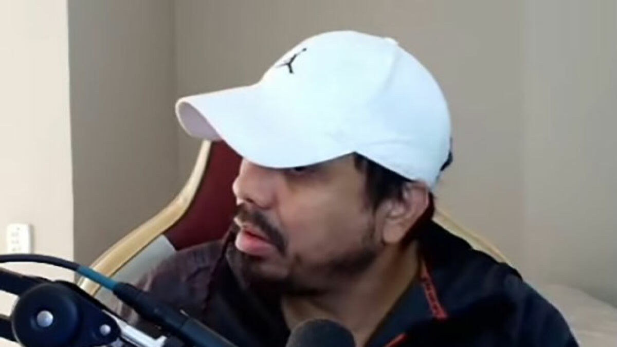 Man wearing white cap streaming with microphone nearby, showing shocked expression after tragic event involving 2-year-old drowning.