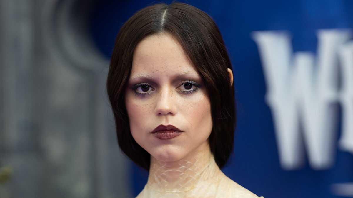 Jenna Ortega with dark makeup and sleek hairstyle, sparking fans' theories about buccal fat removal after premiere looks