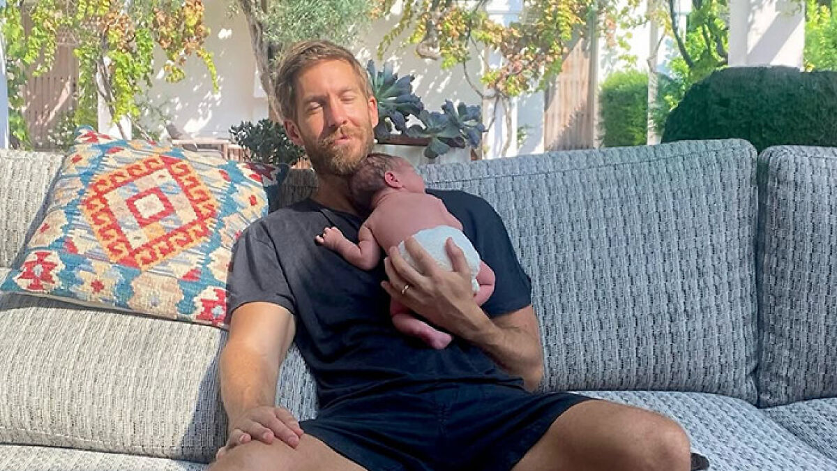 Calvin Harris holding newborn baby on couch outdoors, fans react to placenta encapsulation process photos shared.