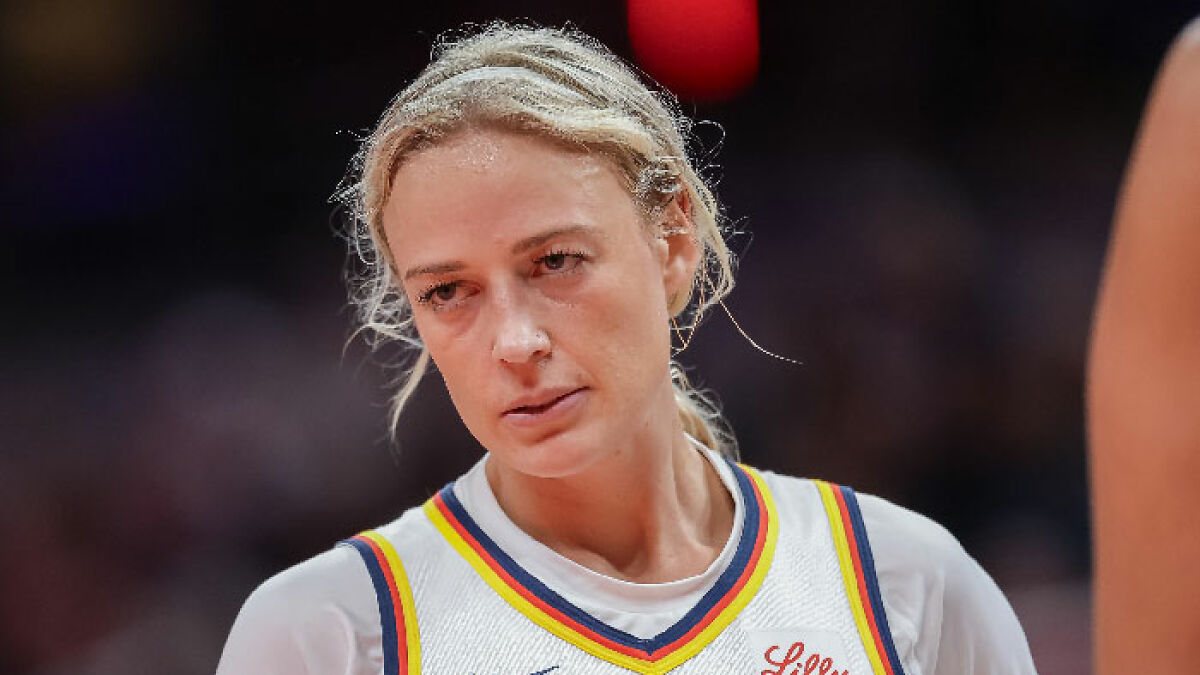 WNBA star player during game, reacting to viral footage of flying d***o incident on the court.