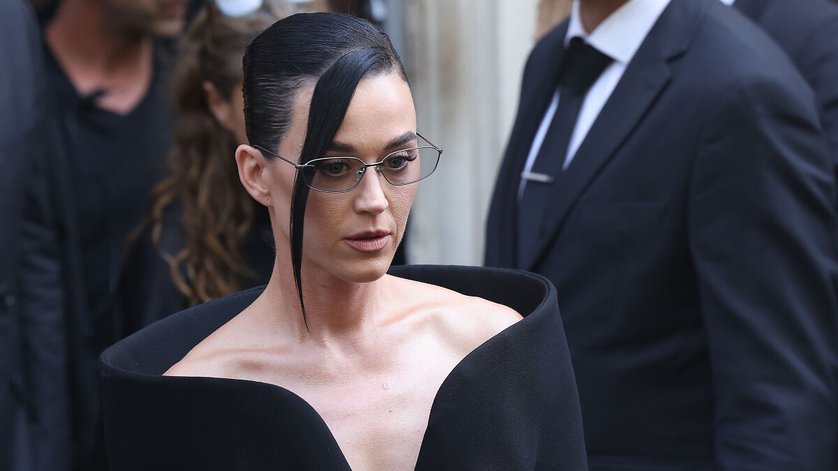 Katy Perry wearing glasses and a black outfit, appearing serious while attending a court-related event about Chris Pratt.