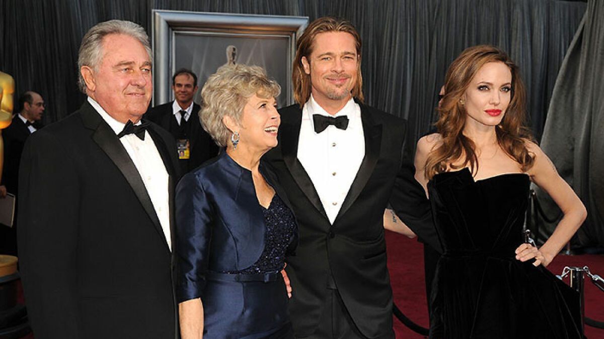Brad Pitt dressed in tuxedo with family on red carpet, highlighting viral final public message to his mom.