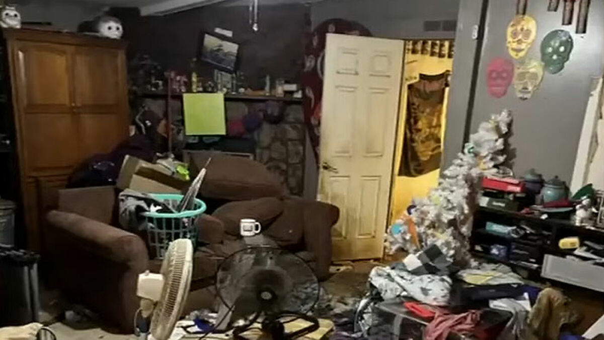 Cluttered and messy living room inside Florida home where mother abandoned child and seven dogs for two weeks.