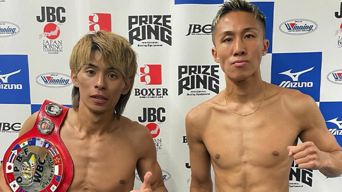 Two Japanese boxers posing shirtless after a match, one wearing a championship belt, related to darkest night boxing history.