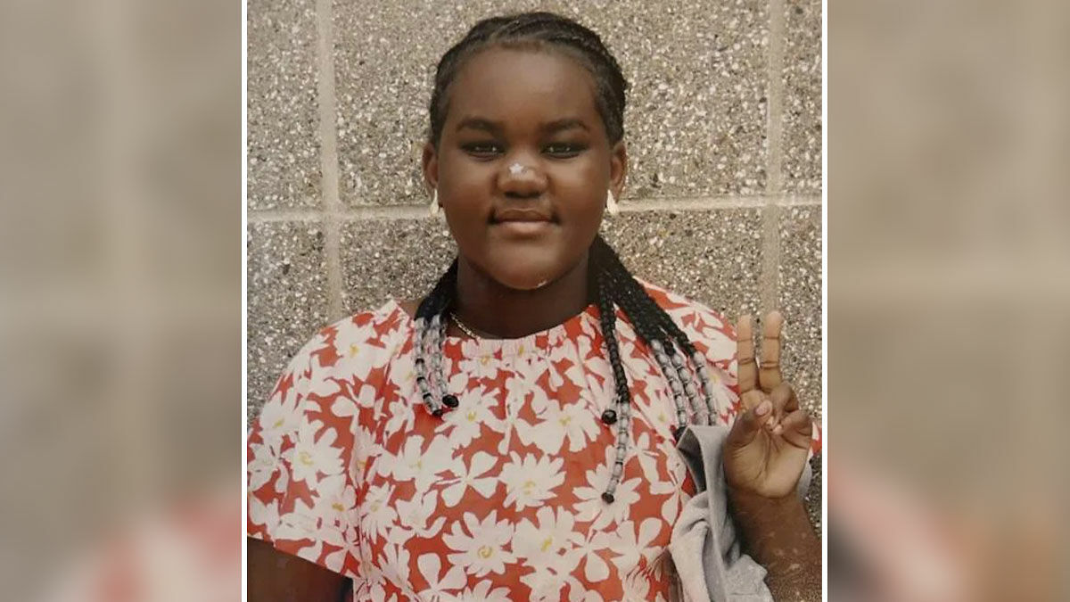 Young girl in floral shirt making a peace sign, related to hospital firing nurses after patient takes her own life.